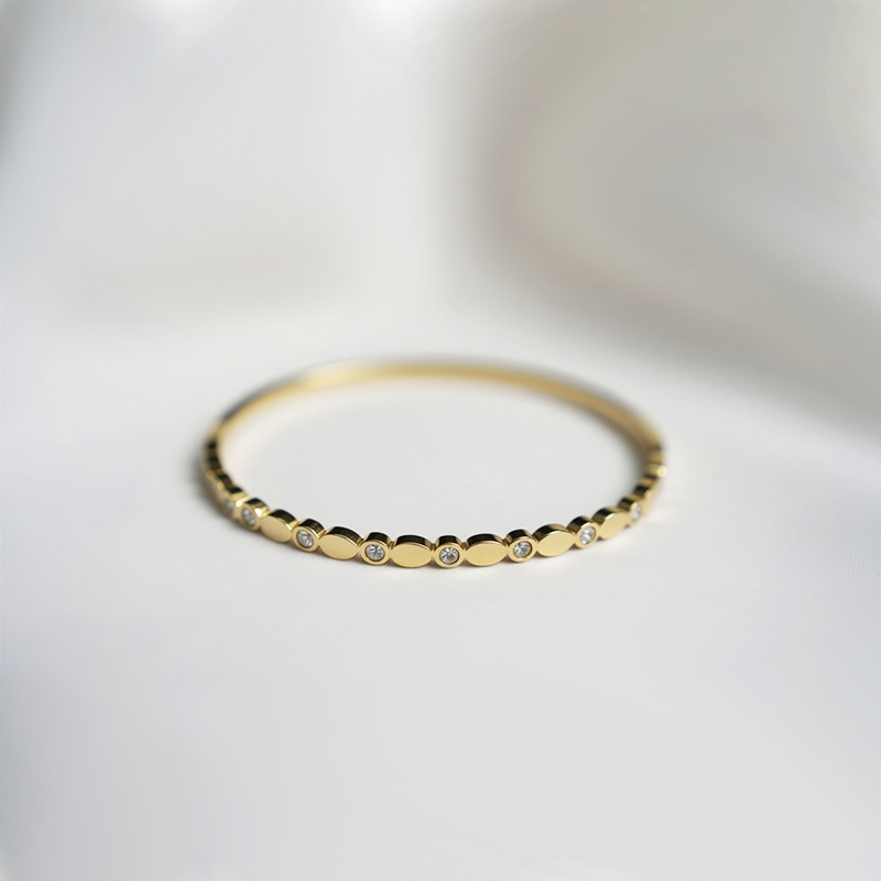 Gold Toned Bangle Style Bracelet With Sparkling Cubic Zirconia Stones In Bezel Dots