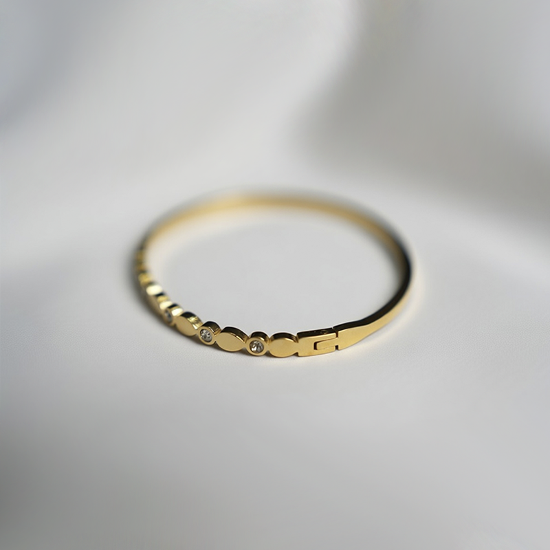 Gold Toned Bangle Style Bracelet With Sparkling Cubic Zirconia Stones In Bezel Dots