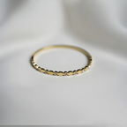 Gold Toned Bangle Style Bracelet With Sparkling Cubic Zirconia Stones In Bezel Dots